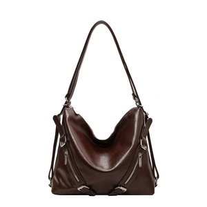 Dark brown leather tote bag with glossy finish and dual zipper detail in a minimalist design