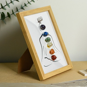 Meditation photo frame with seven colorful natural chakra raw stones and wooden frame