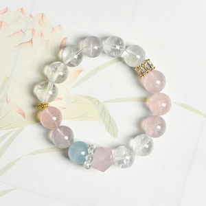 Natural pink quartz beaded bracelet with aquamarine and crystal beads on a floral background