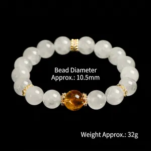 White phantom quartz 10mm bead bracelet with yellow crystal and gold spacers on black