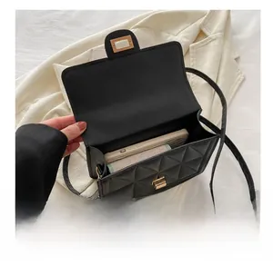 Capacity view of black quilted crossbody bag showing interior for phone and card holder