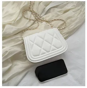 Detailed close-up of a white quilted crossbody bag with a gold chain strap and size reference