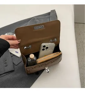 Interior view of brown quilted crossbody bag showing spacious storage for daily items