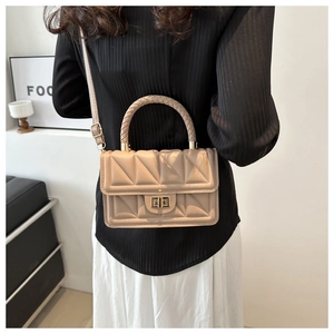 Quilted beige flap bag shown on a model with an elegant woven handle and twist-lock