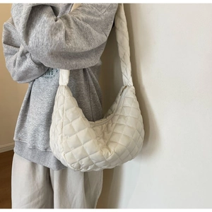 Detailed close-up of the white quilted nylon shoulder bag showing puffy diamond textures