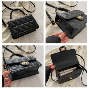 Detail view of black quilted crossbody bag with gold hardware and woven handle accents