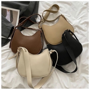 Flat lay of four vintage saddle bags in dark brown, khaki, black, and beige colors