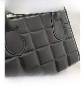 Close-up of premium black quilted leather handbag showing fine stitching and luxury texture