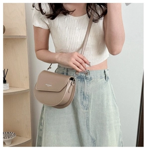 Beige saddle bag with Ghost Moment print and adjustable strap in minimalist Korean style