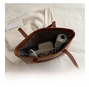 Macro view of brown leather tote bag interior showing large capacity for daily essentials