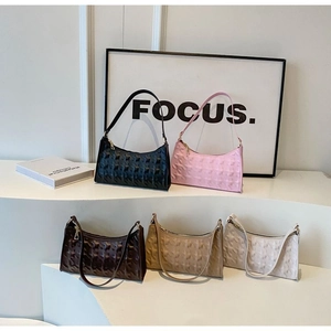 Close-up of quilted pattern and gold zipper details on multiple color shoulder bags