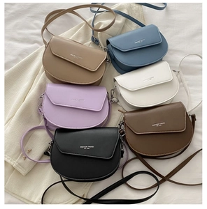 Close-up of saddle cross-body bags in six different colors with a sleek leather texture