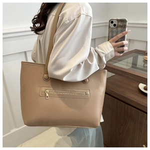 Detail of light khaki PU leather tote bag with functional exterior zipper pocket