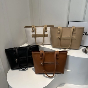Detail showing four medium tote bags with front zippers in white, khaki, black and brown