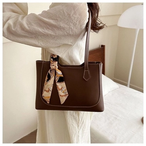 Brown faux leather tote bag with contrast stitching and floral silk scarf detail
