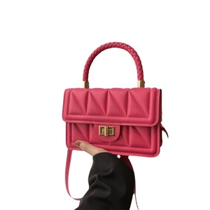 Elegant rose pink quilted crossbody bag with triangle stitching and gold metal clasp