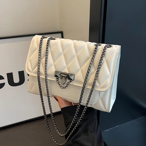 Elegant white quilted leather crossbody bag with black chain and metal clasp closure