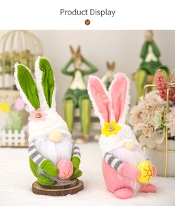 Detailed view of handmade Easter gnome plush toys with pink ears and floral accents