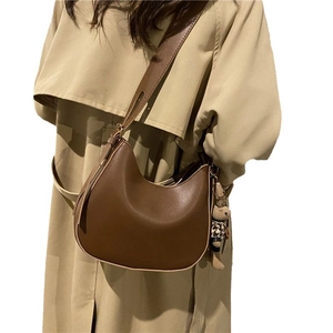 Brown retro hobo saddle bag with adjustable strap and cute plush bunny charm for women