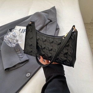 Elegant black underarm bag with star-shaped quilting and gold zipper for women