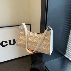 White faux leather underarm bag with embossed stars and chic minimalist shoulder strap