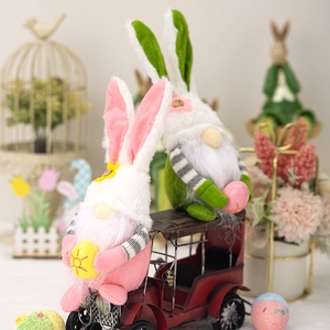 Close-up of Easter plush gnomes with bunny ears and eggs on a vintage red toy car