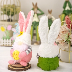 Easter rabbit gnomes with pink bunny ears holding painted egg for home decoration