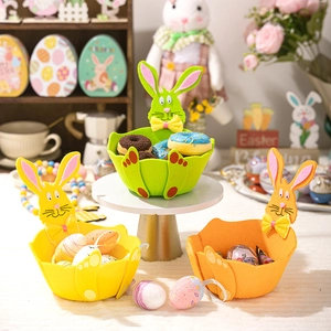 Three colorful Easter felt baskets with bunny ears and bows for candy storage and decor
