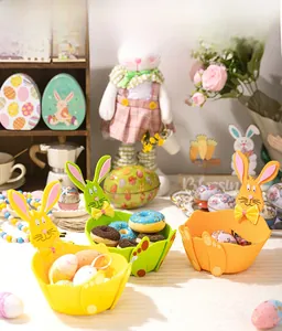 Three colorful felt Easter bunny baskets with long ears and bows for candy storage