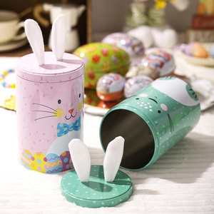 Detail of Easter tin storage jars with cute bunny ears and colorful egg patterns