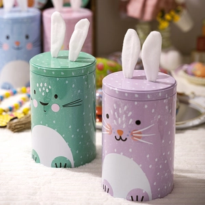 Close-up of Easter bunny tin jars with plush ears for candy and gift storage