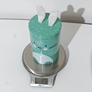 Digital scale showing the 137.6g weight of this green Easter bunny tin storage box