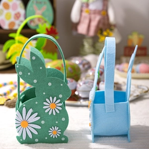 Detailed view of green and blue felt Easter bunny gift baskets on a white soft surface