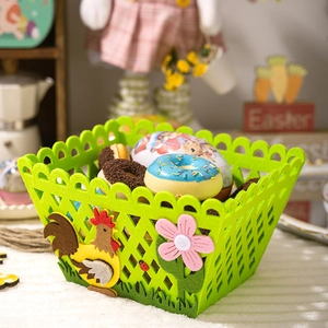 Detail of green felt Easter basket featuring a yellow rooster and flower decorations