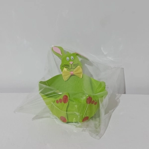 Detail of green felt Easter bunny basket with pink ears and yellow bow decoration