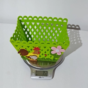 Detail of a lightweight 35.3g green felt Easter basket with laser-cut hollow pattern