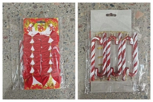 Close-up of red Christmas bows and candy cane hangers in festive retail packaging
