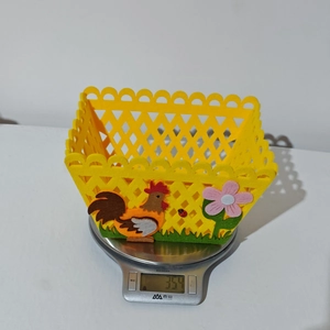 Close-up of yellow felt Easter basket with rooster and flower detail weighing 35.4g