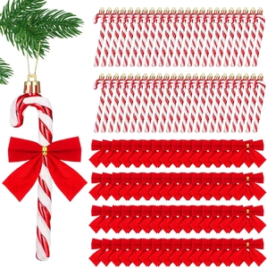Christmas candy cane hanging set with red white swirls and velvet bows on pine branch