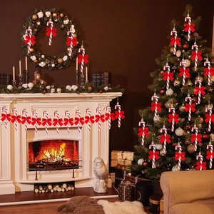 Christmas candy cane hanging ornaments with red bows on a festive fireplace background