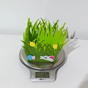 Close-up of green felt Easter basket showing bunny and flower details on a kitchen scale