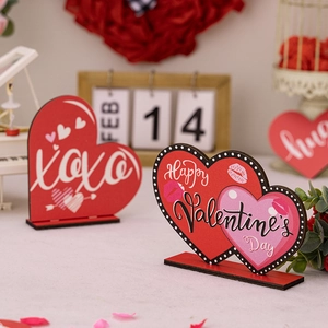 Close-up of wooden Valentine's Day table signs with XOXO and Happy Valentine's Day text
