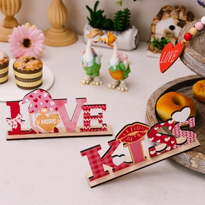 Detail of LOVE and KISS wooden gnome ornaments for Valentine home tabletop decor