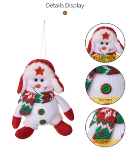 Detail of plush Christmas snowman ornament with knit scarf and red star pilot hat