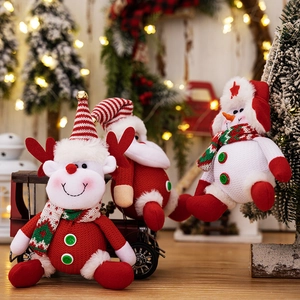 Detail of Christmas plush ornaments with reindeer and snowman on a festive background