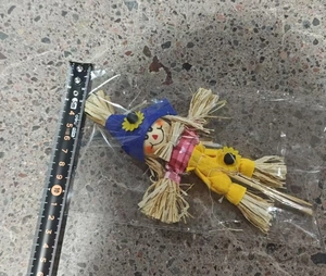Detailed view of 15cm fall scarecrow pick with ruler for size reference