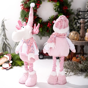 Detailed close-up of pink and white reindeer dolls with sequins and knit texture
