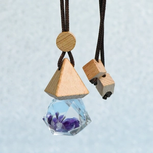 Car perfume pendant with triangular crystal bottle, wooden lid, and purple dried flowers