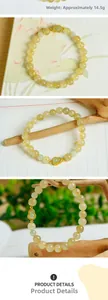 Detailed view of 7mm golden rutilated quartz bracelet with Hetian jade gourd charm