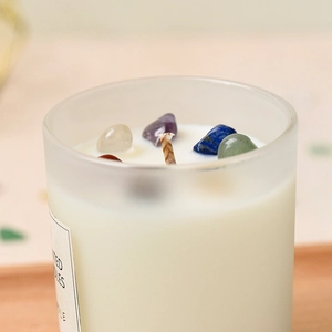Frosted glass scented candle with natural crystal stones and white soy wax in a jar